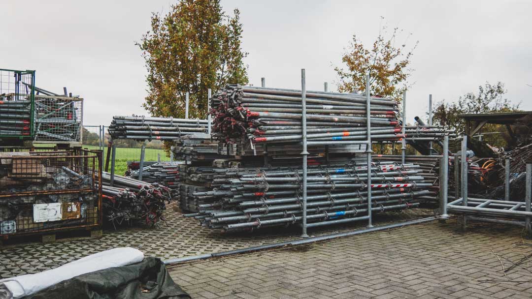 Secured construction site with stored scaffolding materials and fencing to support construction site security